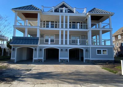 A large building with metal roofing and a wraparound balcony on two floors