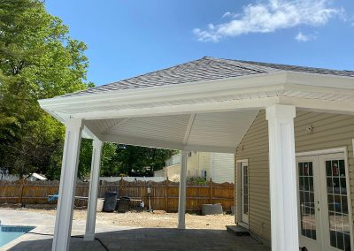 A patio outside a house with white gutters