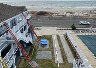 A building with white gutters by a large body of water